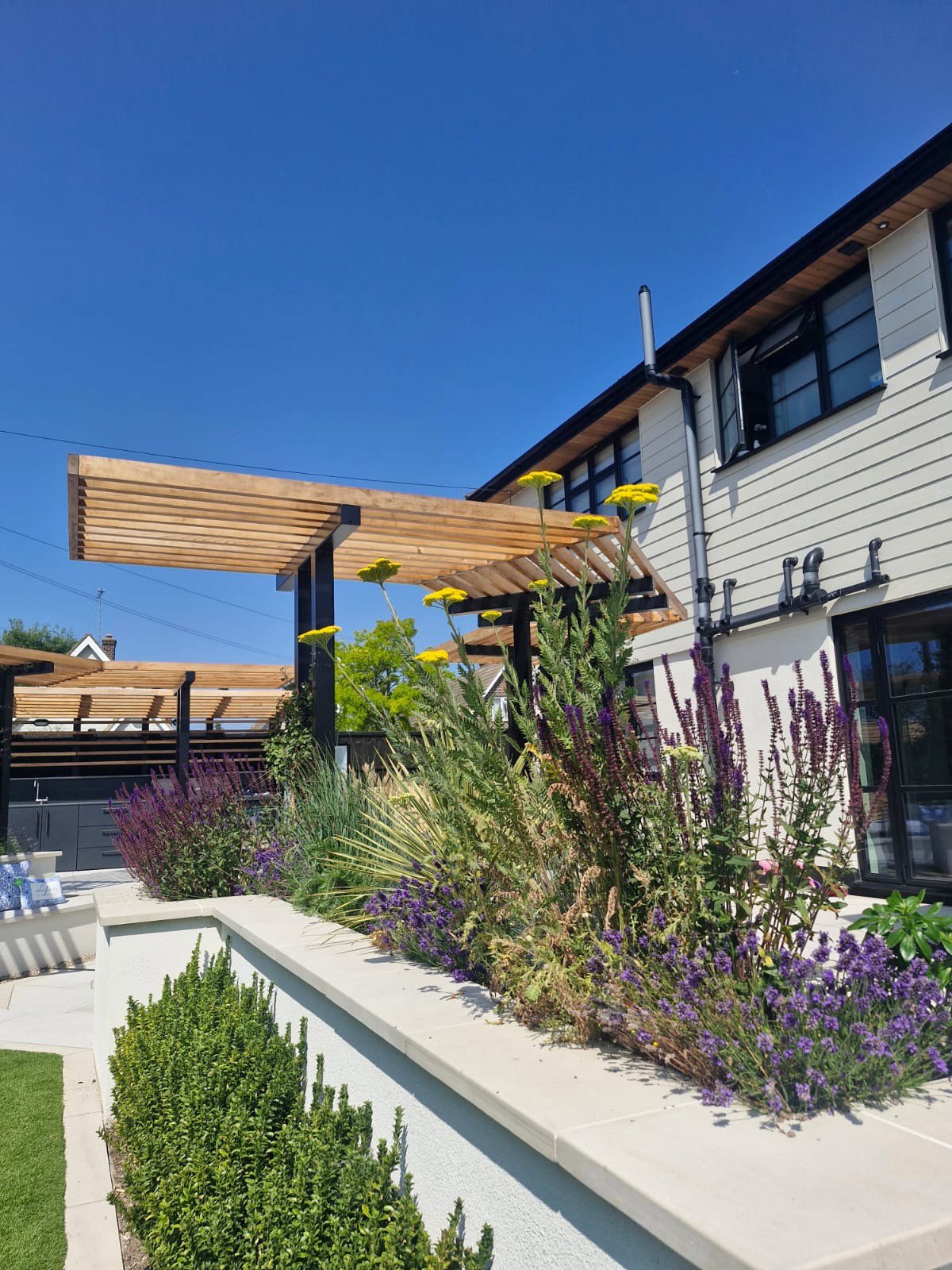 Raised planters and planks around lawn