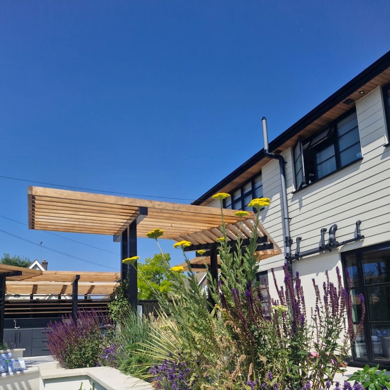 Raised planters and planks around lawn