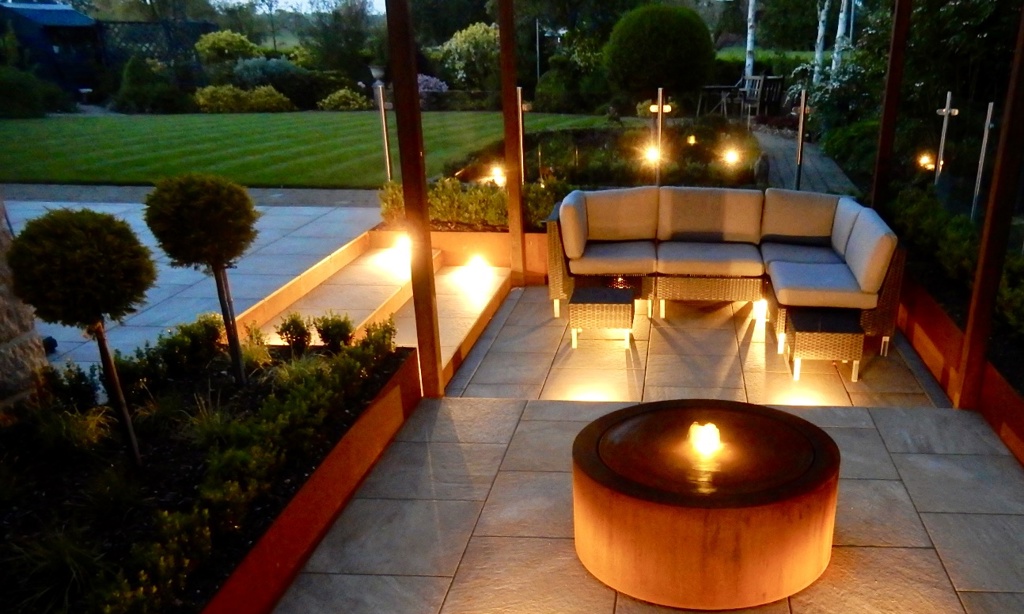 A contemporary garden with water and lighting