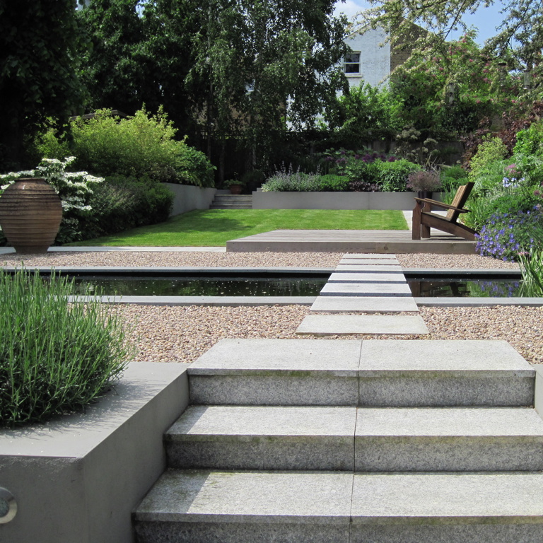 Stepping stones across formal pond to cedar deck