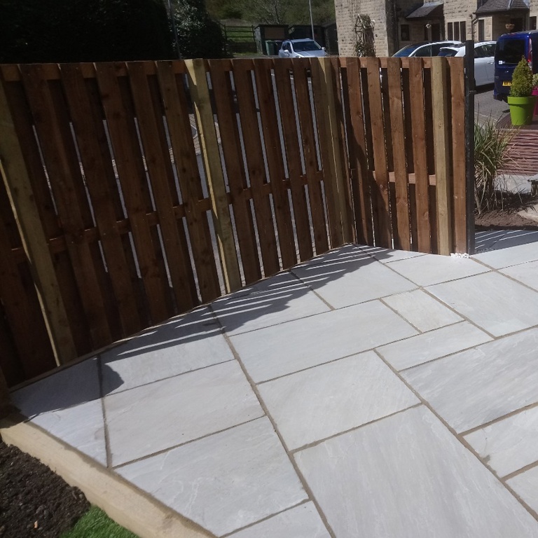 Stone paving and Fence on an area previously covered by a Laurel Bush