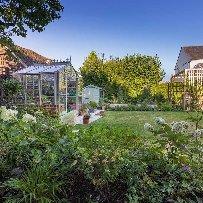 View of greenhouse and pergola