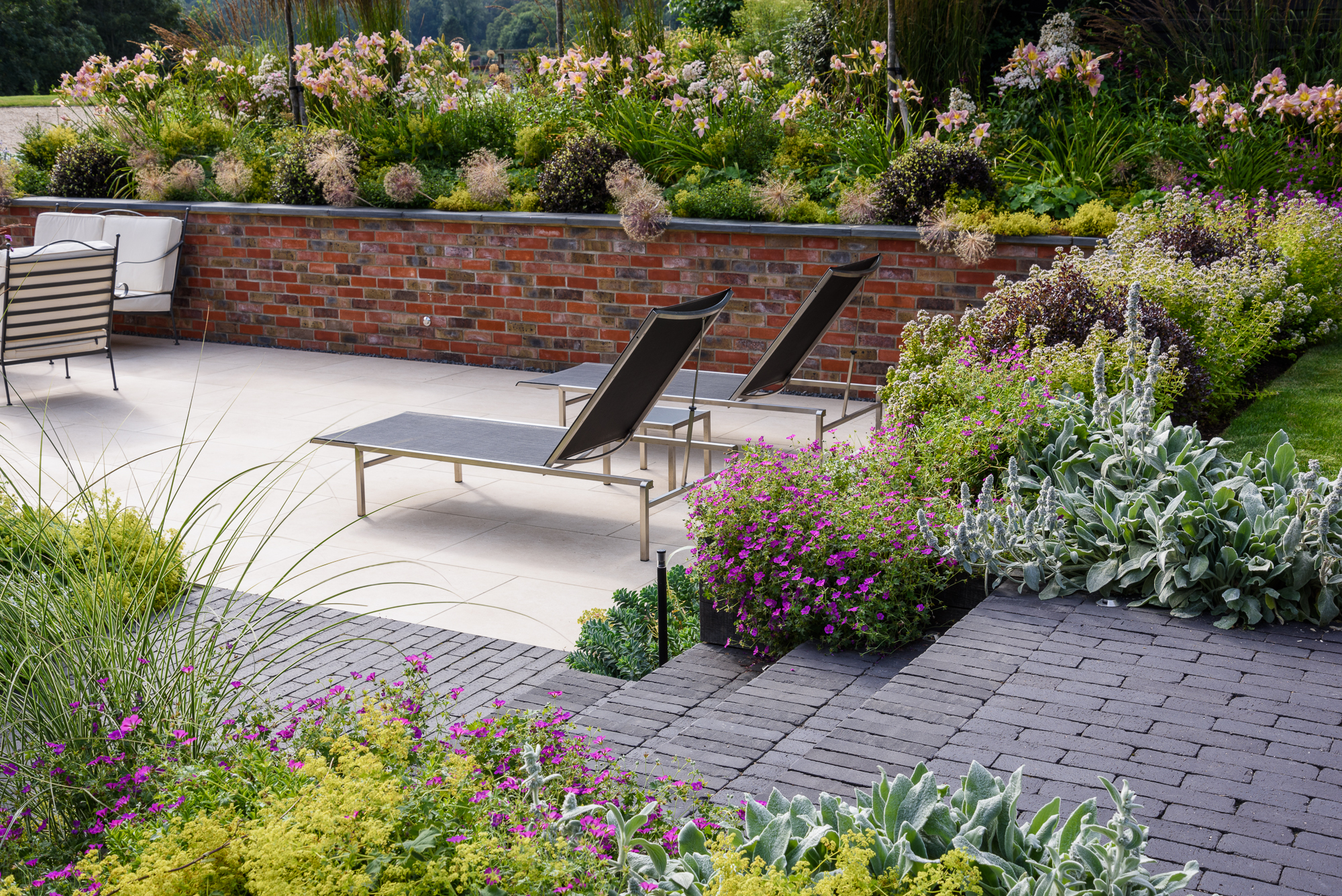 Sunken terrace with clay paver steps and detail and porcelain paving