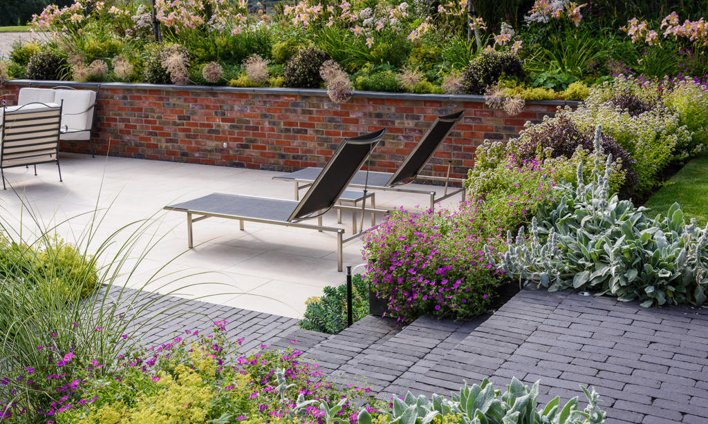 Sunken terrace with clay paver steps and detail and porcelain paving