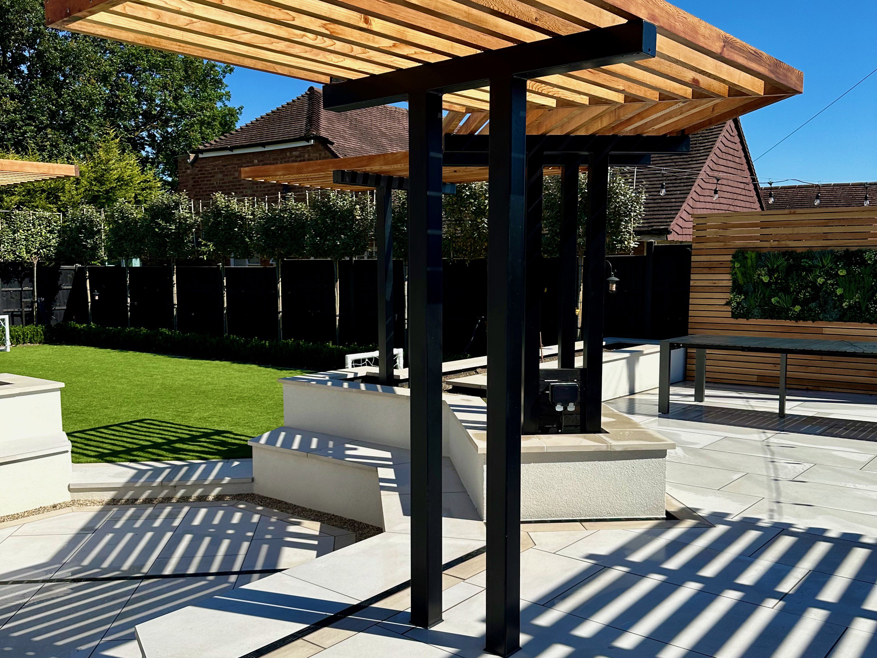 Sunken fire-it with seating area and bespoke cedar pergola
