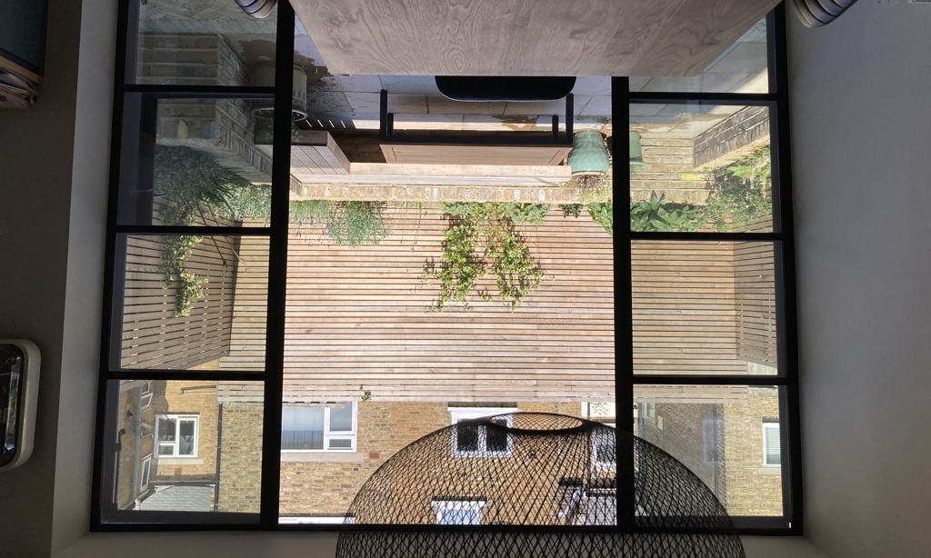 View out to courtyard from kitchen through crittall doors