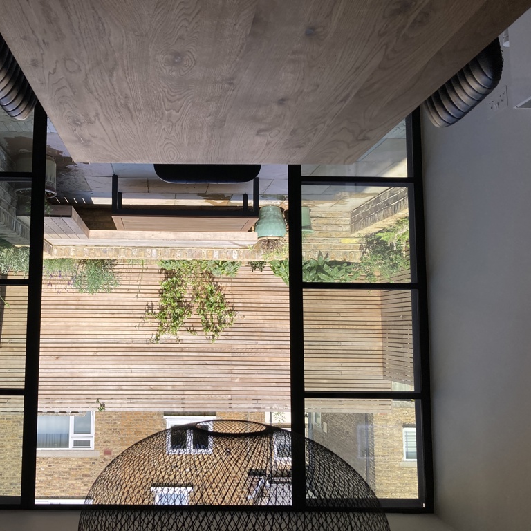 View out to courtyard from kitchen through crittall doors