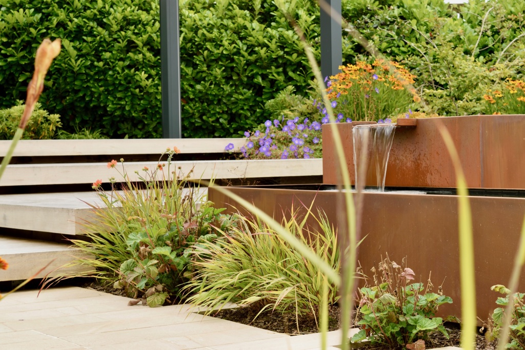 Water feature nestled in planting