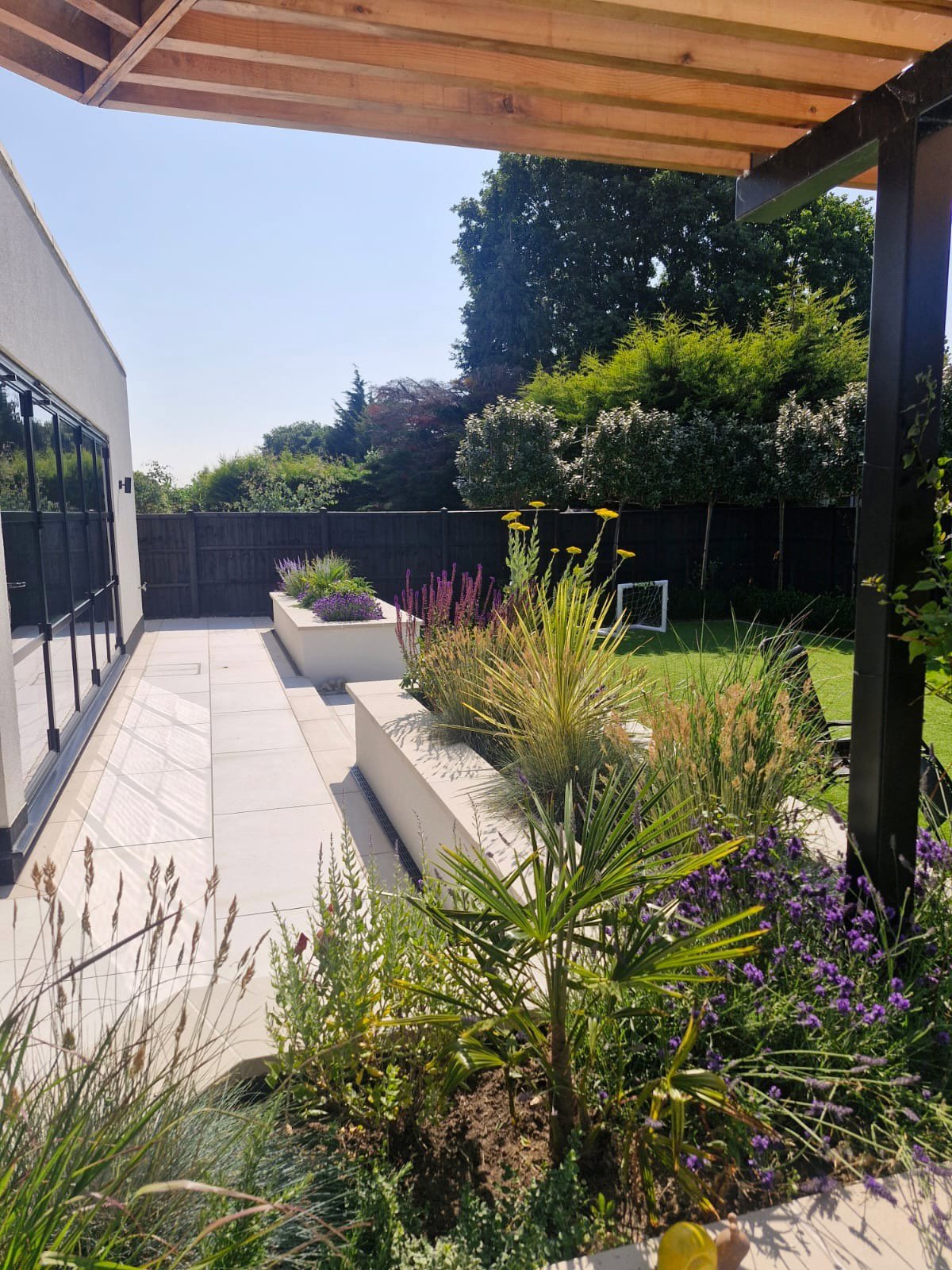 Raised planters and porcelain paving