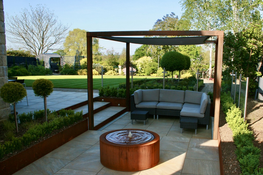 A contemporary garden with water and lighting