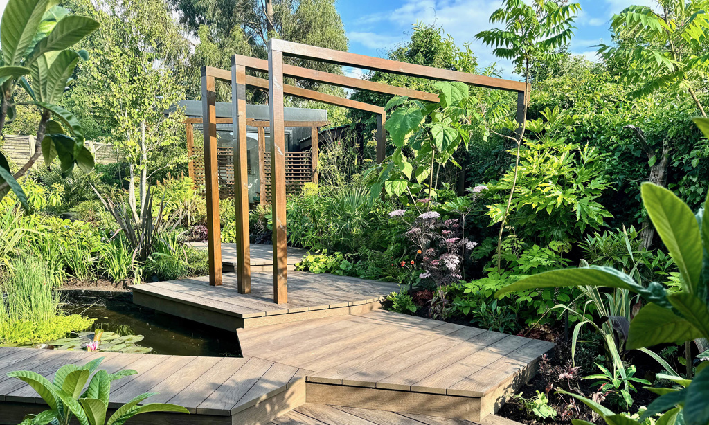 Multi-level decks leading up the garden through exotic planting