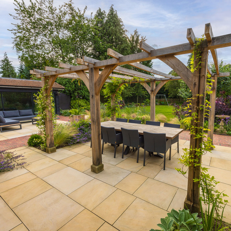 Oak pergola strewn with scented climbers